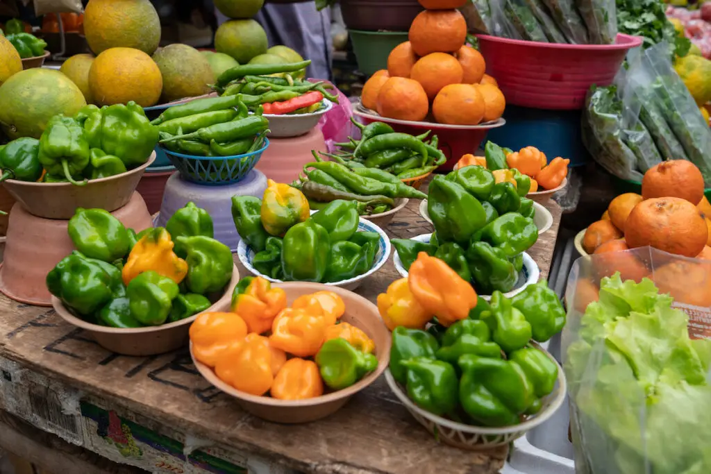 Bowls of local Florida green and orange peppers.